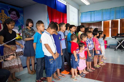 CHIANGRAI, THAILAND - AUG 10: unidentified children singing for Her Majesty Queen Sirikit in church on August 10, 2014 in Chiangrai, Thailand. Thai people in every religions always pray for the Queen in the occation of Her Mejesty Queen's Birthday (on August, 12)