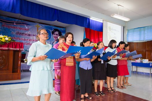 CHIANGRAI, THAILAND - AUG 10: unidentified women singing for Her Majesty Queen Sirikit in church on August 10, 2014 in Chiangrai, Thailand. Thai people in every religions always pray for the Queen in the occation of Her Mejesty Queen's Birthday (on August, 12)