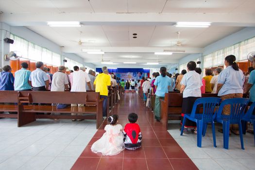 CHIANGRAI, THAILAND - AUG 10: unidentified people praying for Her Majesty Queen Sirikit in church on August 10, 2014 in Chiangrai, Thailand. Thai people in every religions always pray for the Queen in the occation of Her Mejesty Queen's Birthday (on August, 12)