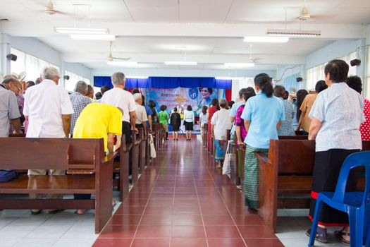 CHIANGRAI, THAILAND - AUG 10: unidentified people praying for Her Majesty Queen Sirikit in church on August 10, 2014 in Chiangrai, Thailand. Thai people in every religions always pray for the Queen in the occation of Her Mejesty Queen's Birthday (on August, 12)