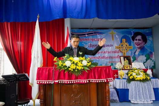 CHIANGRAI, THAILAND - AUG 10: unidentified man on pulpit praying for Her Majesty Queen Sirikit in church on August 10, 2014 in Chiangrai, Thailand. Thai people in every religions always pray for the Queen in the occation of Her Mejesty Queen's Birthday (on August, 12)