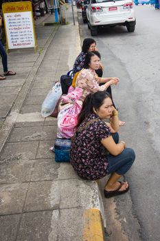 CHIANGRAI, THAILAND - AUG 12: unidentified people waiting for bus at the roadside on August 12, 2014 in Chiangrai, Thailand.