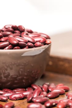 Bowl with red beans close up on wooden table