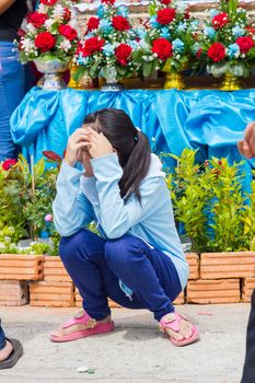 CHIANGRAI, THAILAND - AUG 12: unidentified woman puts hands up to protect sunshine on August 12, 2014 in Chiangrai, Thailand.