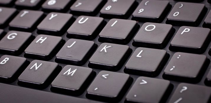 keyboard with black buttons and white letters