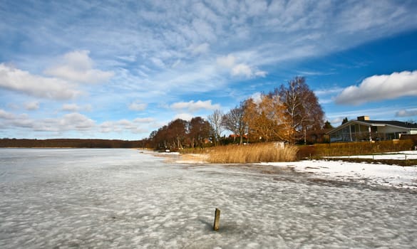 Iced lake in sun in denmark in winter