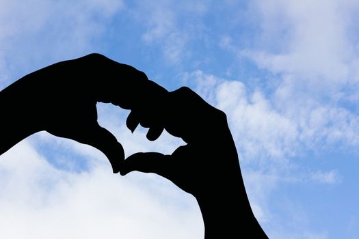 bat shape hand silhouette in blue sky and cloud, with copyspace