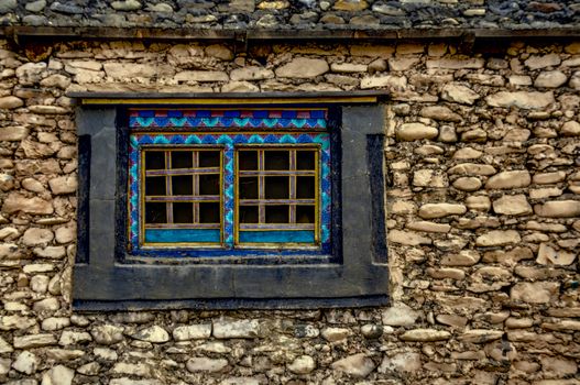 Traditional decorated window on old stone nepalese house