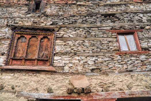 Traditional decorated windows on old stone nepalese house