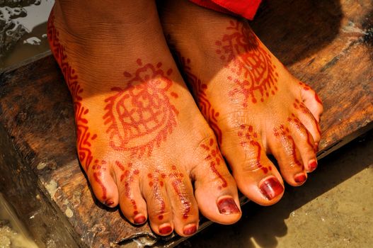 Traditional henna on brides feet on wedding in Bangladesh
