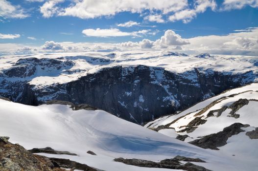 Deep gorge in Norwegian mountains hidden in the shadow, near Trolltunga