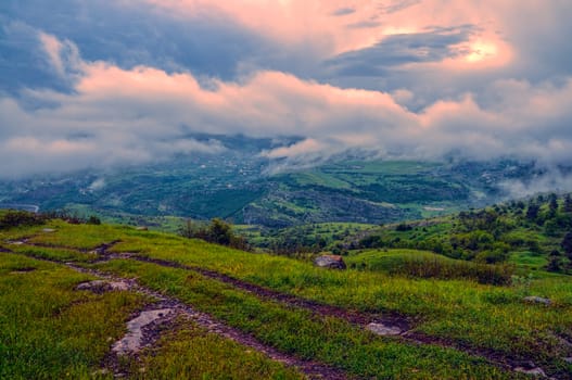 Stormy clouds above green landscape of mountainous Karabakh