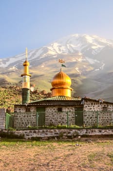 Mosque underneath volcano Damavand, highest peak in Iran