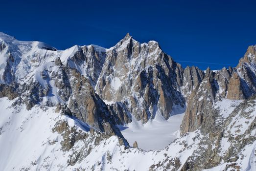 Breathtaking view of snowy mountains from the top in Valle Blanche