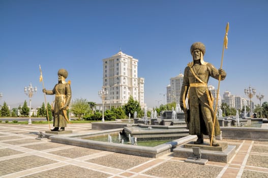 Statues around monument of independence in Ashgabat, capital city of Turkmenistan