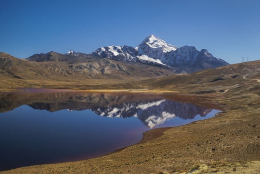 Picturesque lake with Huayna Potosi mountain in the background, peak in Bolivian Andes