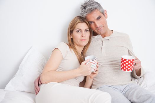 25-30, adult, apartment, attractive, bed, bedroom, caucasian, coffee, Couple, fun, handsome, happy, home, horizontal, house, leisure, lifestyle, love, marriage, men, model, nightwear, old, people, person, property, releases, sitting, smile, tea, two, women, years, young