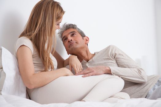 25-30, adult, apartment, attractive, bed, bedroom, caucasian, Couple, fun, handsome, happy, home, horizontal, house, leisure, lifestyle, love, marriage, men, model, nightwear, old, people, person, property, releases, sitting, smile, two, women, years, young