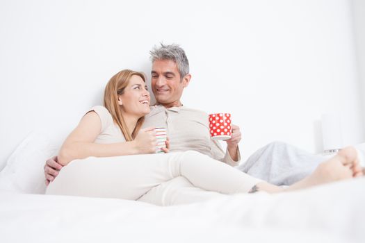 25-30, adult, apartment, attractive, bed, bedroom, caucasian, coffee, Couple, fun, handsome, happy, home, horizontal, house, leisure, lifestyle, love, marriage, men, model, nightwear, old, pc, people, person, property, releases, sitting, smile, tablet, tea, two, women, years, young