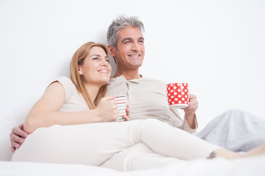 25-30, adult, apartment, attractive, bed, bedroom, caucasian, coffee, Couple, fun, handsome, happy, home, horizontal, house, leisure, lifestyle, love, marriage, men, model, nightwear, old, people, person, property, releases, sitting, smile, tea, two, women, years, young