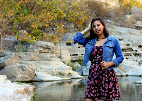 Young Hispanic woman near a creek.