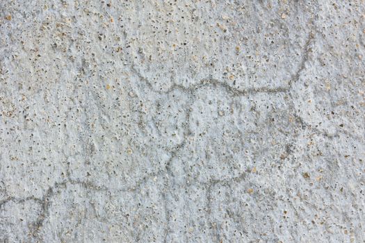 Old worn and cracked asphalt with cracks.