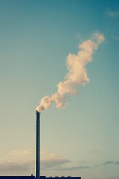 Factory chimney with white smoke