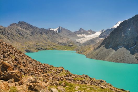 Picturesque turquoise lake in Tien-Shan mountains in Kyrgyzstan