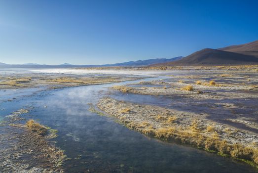 Steamy waters of shallow lake in bolivian desert near Salar de Uyuni.