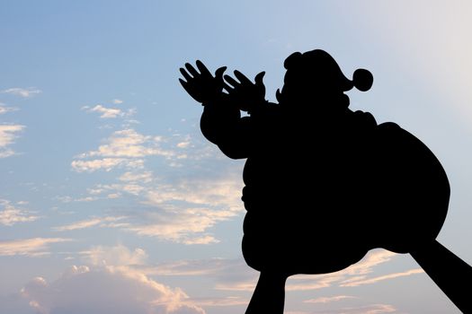 santa clause shape hand silhouette in sky.