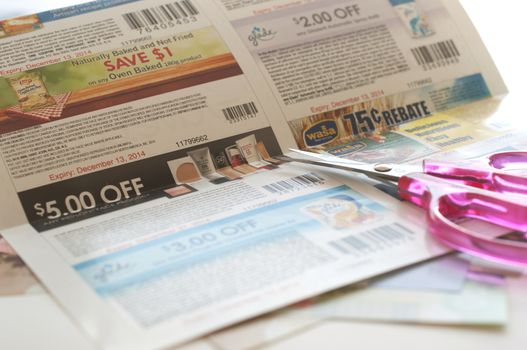 Coquitlam, BC Canada - November 11, 2014 : Woman prepare to cut coupon. All coupons for Canadian store, they are issued by manufacturers of consumer packaged goods Canada. 