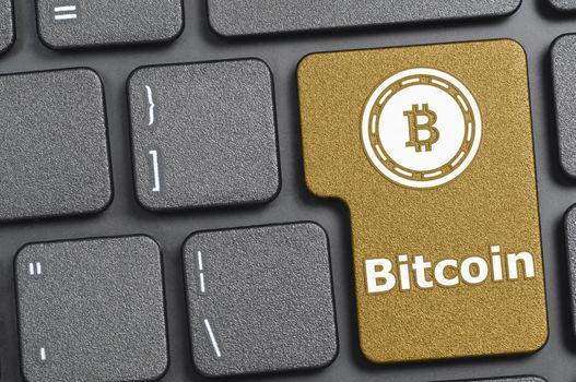 Golden bitcoin key on keyboard