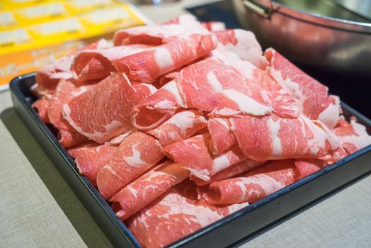 Raw beef in the dish wait to get down boiling in hot pot shabu