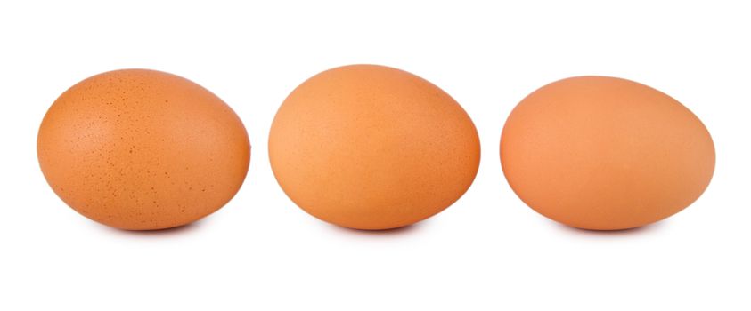 Three fresh brown eggs isolated on a white background