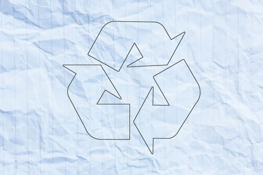 Recycle logo on crumpled paper.