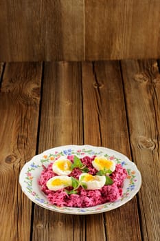 Beetroot salad with mint and boiled eggs with space background vertical