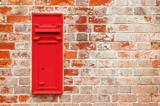 postal mailbox against a red brick wall with cop[y-space