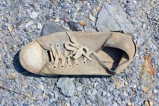 abandoned old canvas shoes have damaged .