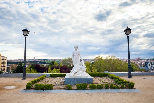 Madrid, Spain - May 6, 2012: "The miracle of the angel and San Isidro" sculpture in Dalieda de San Francisco park on a sunny spring day in La Latina, Madrid, Spain