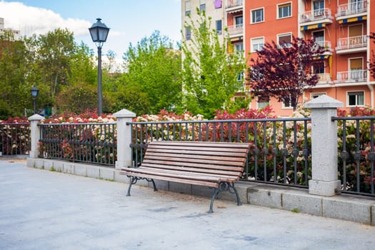 Bench in front of a typical residatial building in La Latina, Madrid, Spain
