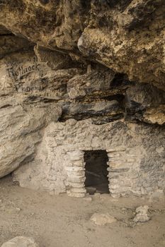 Cliff dwelling with historic paint graffiti advertisement