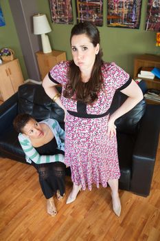 Female spouse with fatigued pregnant woman with hands on hips