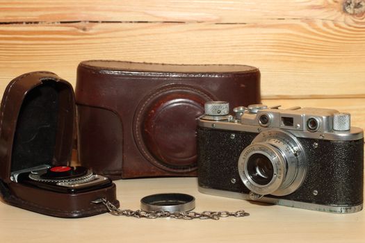 Vintage camera on a wooden background. light meter