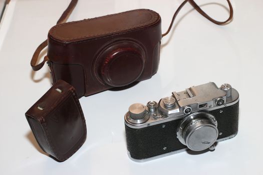 Isolated vintage camera,light meter and leather cover