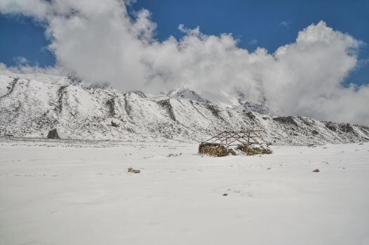 Ruins of cabin in Himalayas mountains near Kanchenjunga, the third tallest mountain in the world