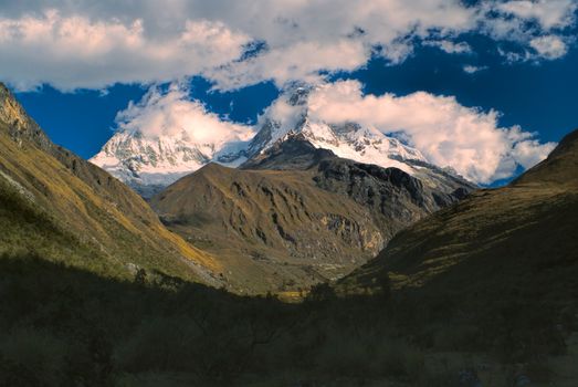 Majestic mountain Huascaran in Andes with its two peaks in clouds, highest mountain in Peru, South America