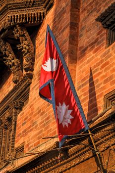 Nepalese flag on brick building wall