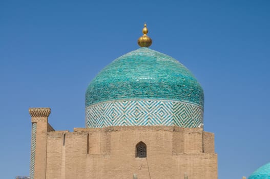 Beautifully decorated turquoise dome on gate tower in Khiva, Uzbekistan