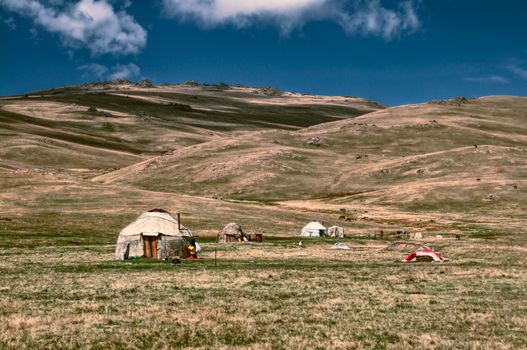 Traditional yurts of nomadic tribes on green grasslands in Kyrgyzstan