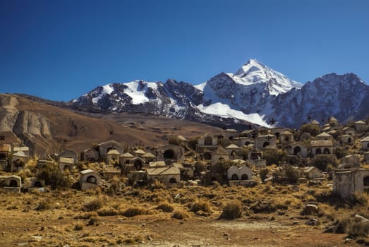 Cemetery with Huayna Potosi mountain in the background, peak in Bolivian Andes